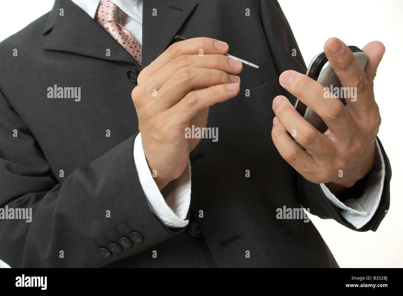 a businessman in grey suit uses an electronic organiser Stock Photo Alamy