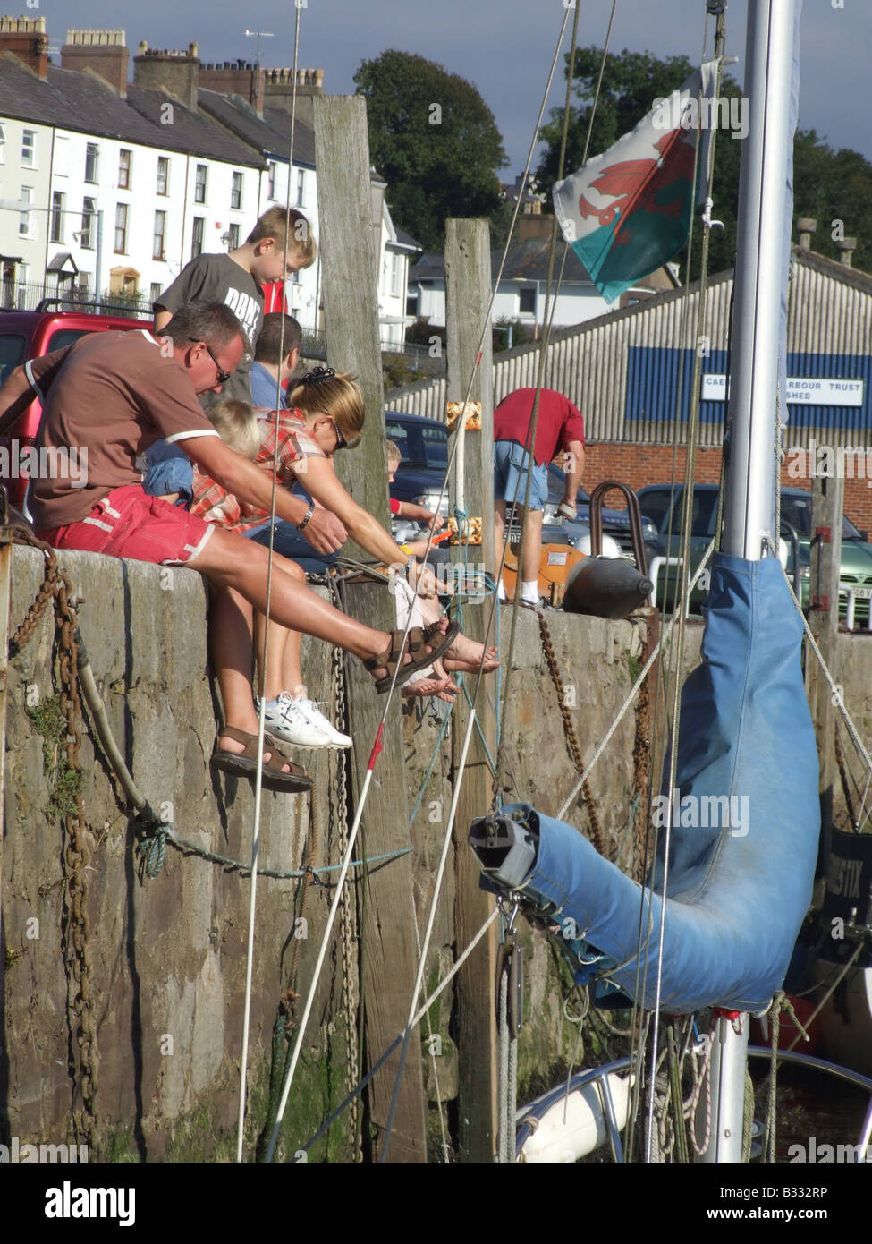 people fishing with crab lines in caernarfon wales Stock Photo Alamy