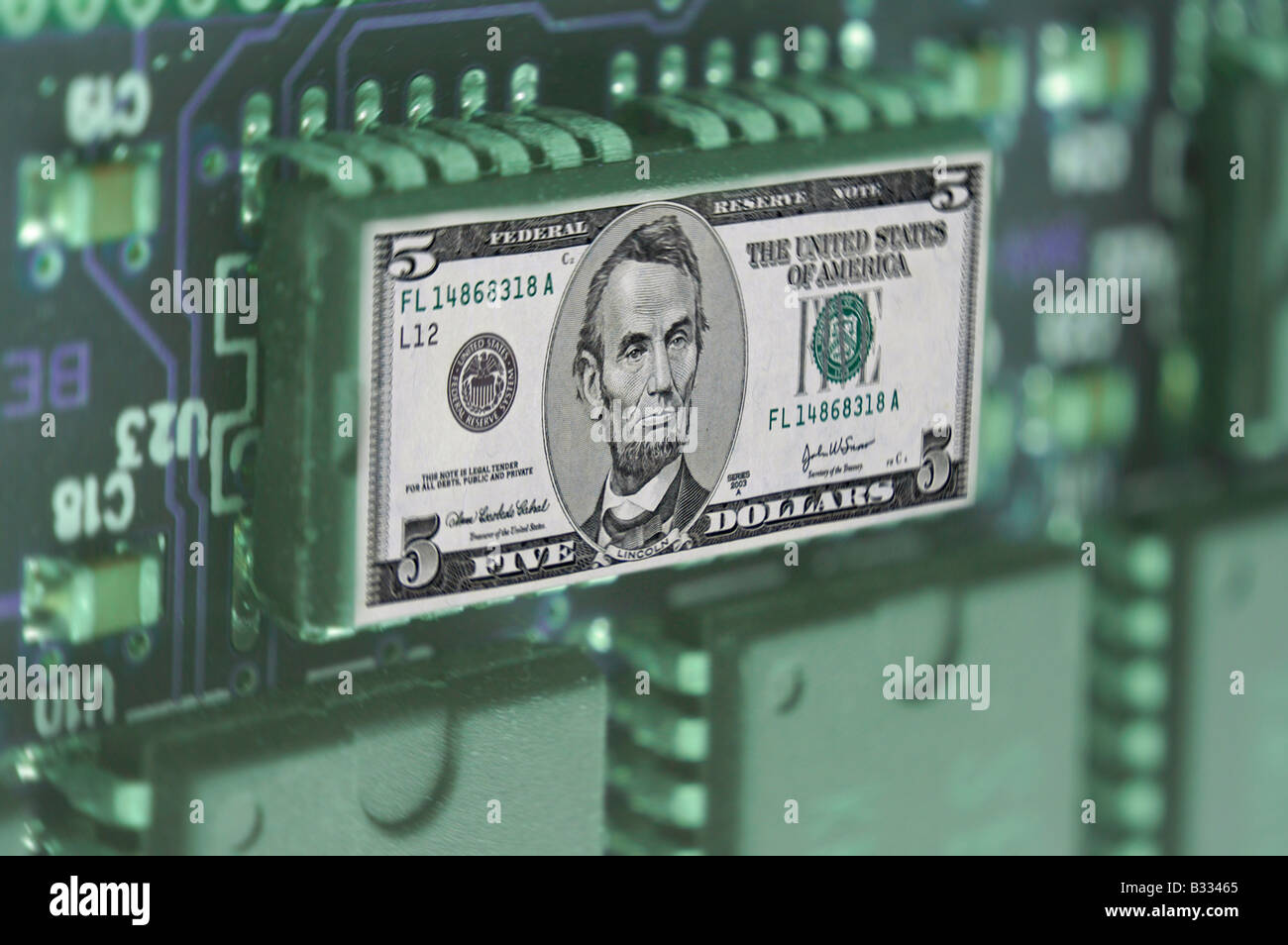 5 dollar note on computer printed circuit board Stock Photo