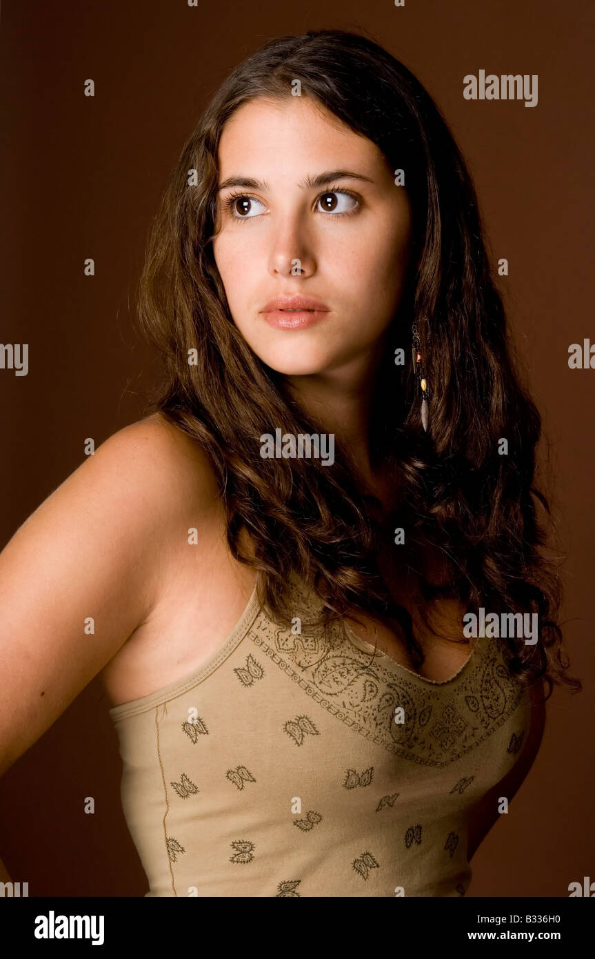 A beautiful and natural young woman on a brown background Stock Photo ...