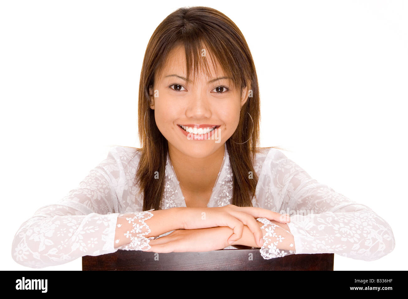 A pretty young asian girl with a gerat smile in a white silk blouse Stock Photo
