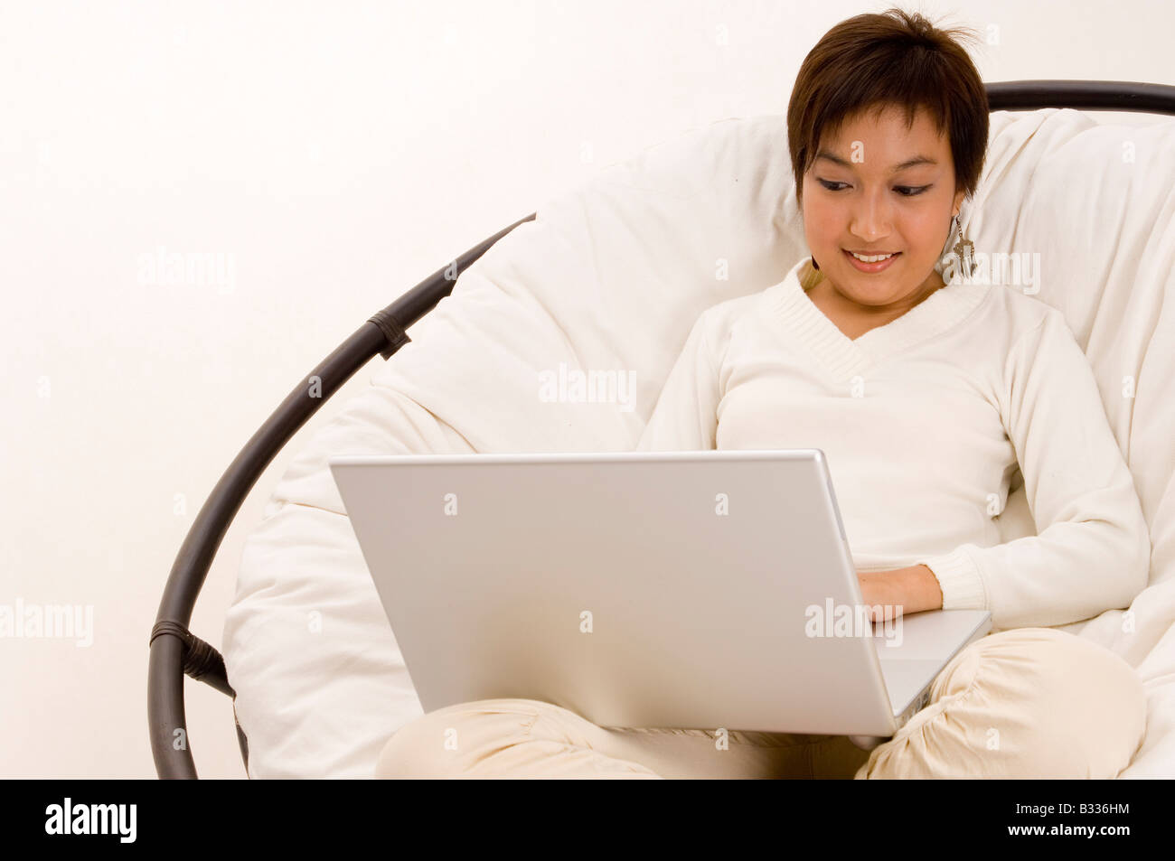 a pretty young asian teenager surfs the internet in a big