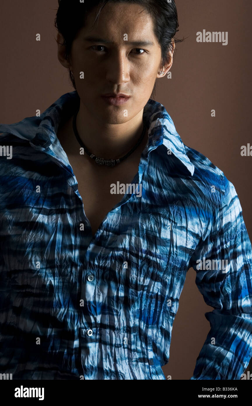 An asian male model in a patterned blue shirt Stock Photo - Alamy