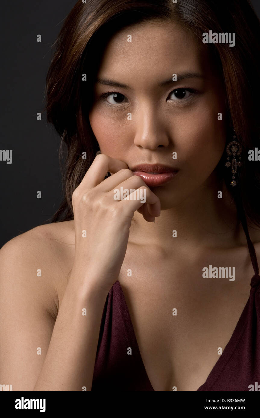 A beautiful asian woman with hand on chin Stock Photo - Alamy