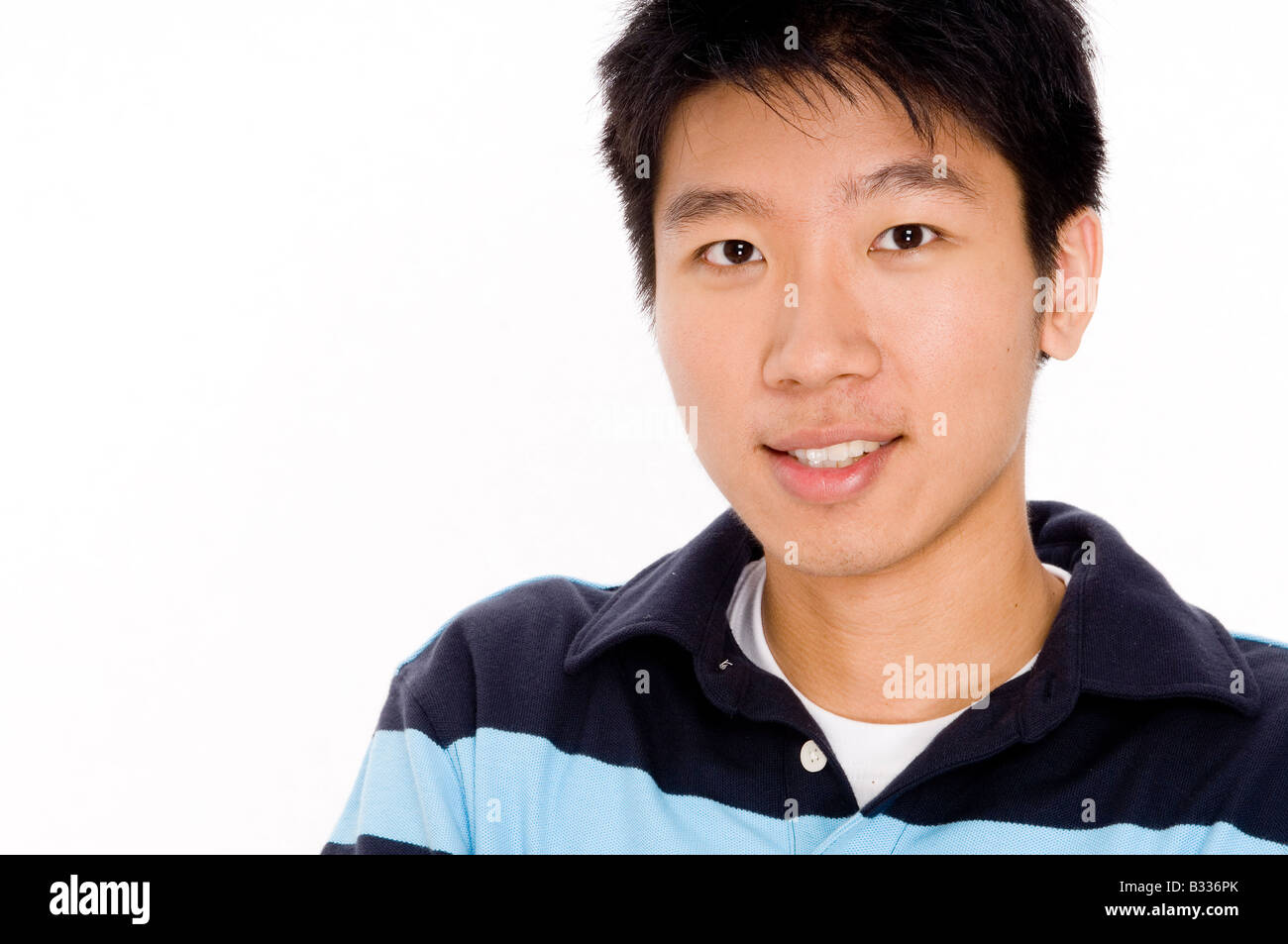A young chinese man in casual top on white background Stock Photo