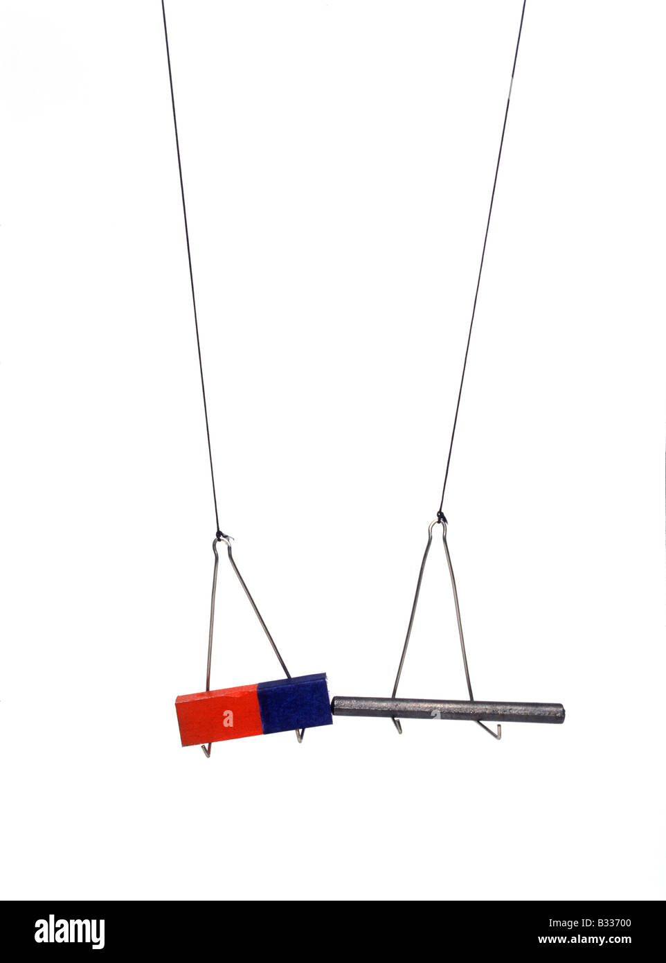 suspended & iron rod are attracted to one another Stock Photo