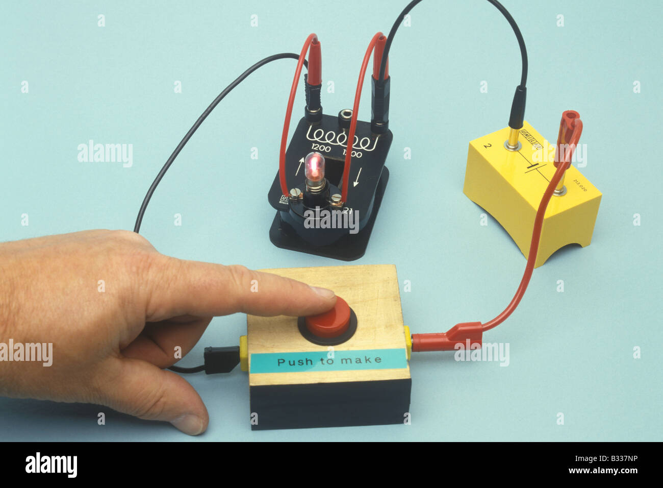 when this circuit is broken an emf of up to 100 volts is induced in the coil enough to light the neon lamp see also B3350M Stock Photo