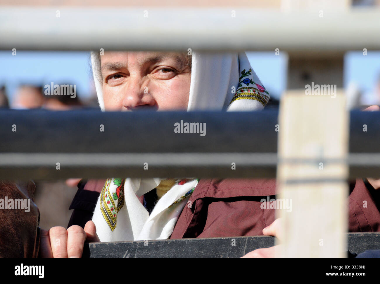 A Greek Orthodox Chrisitan pilgrim waits behind barricading for an annual mass-Baptism ceremony in the River Jordan. Stock Photo