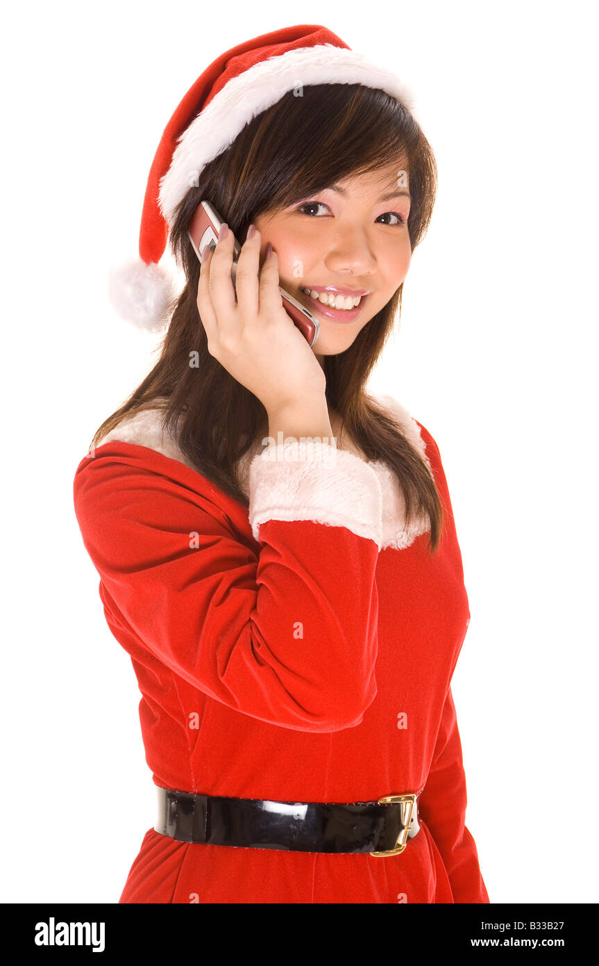 A cute asian woman in a santa costume talks on a cellphone Stock Photo ...