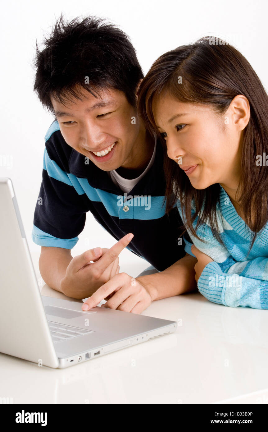 Two friends having fun using a laptop computer Stock Photo