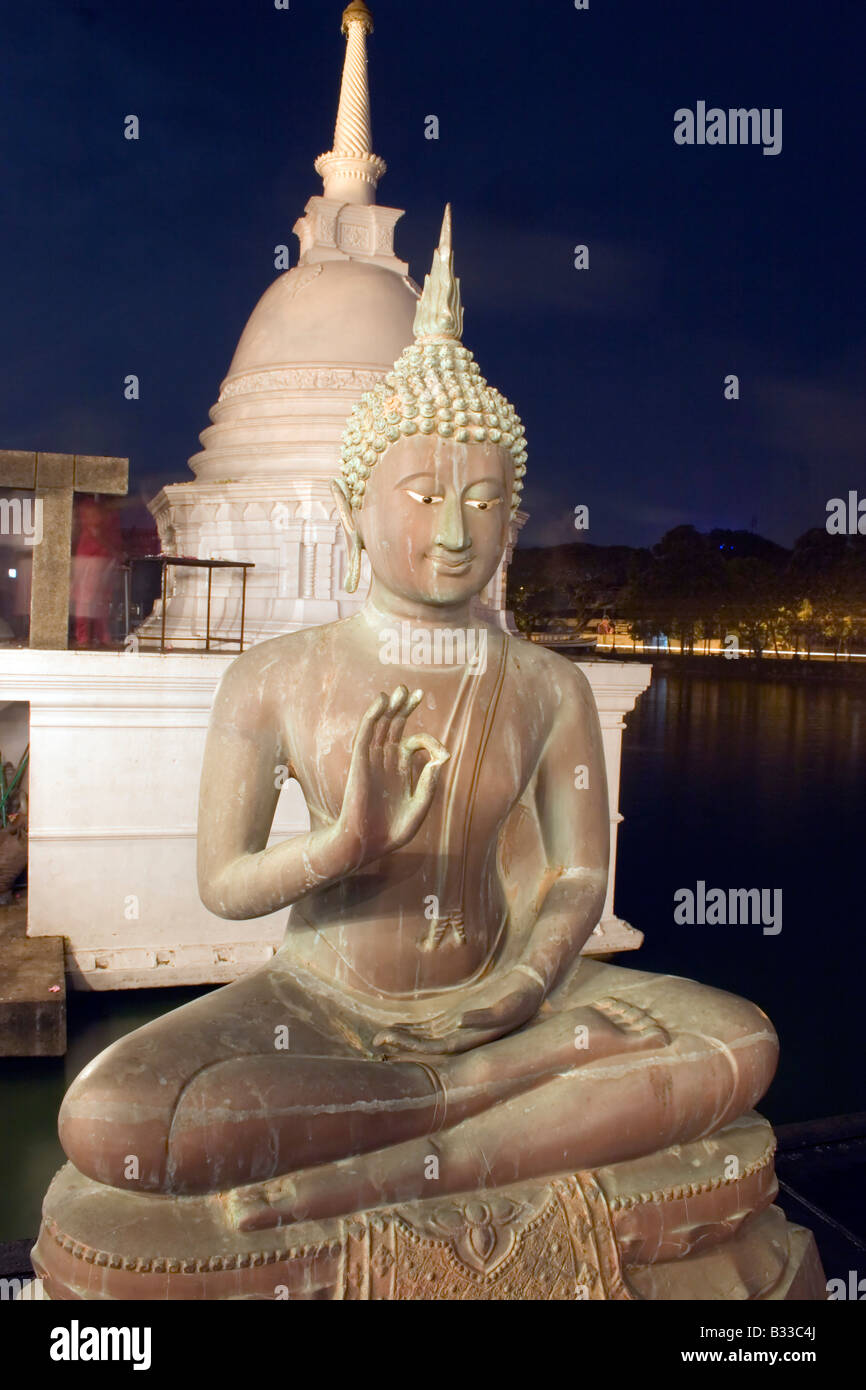 Statue of Buddha sits outside lake temple in Colombo, Sri Lanka Stock ...