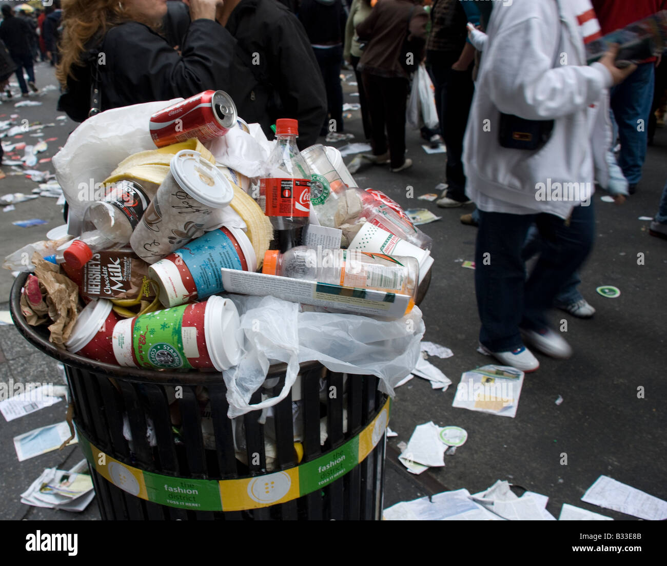 Overflowing trash container and people attending Thanksgiving Day