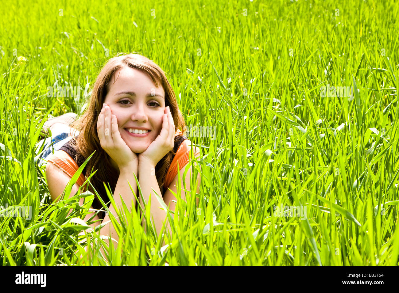 Young happy woman in the grass Stock Photo - Alamy