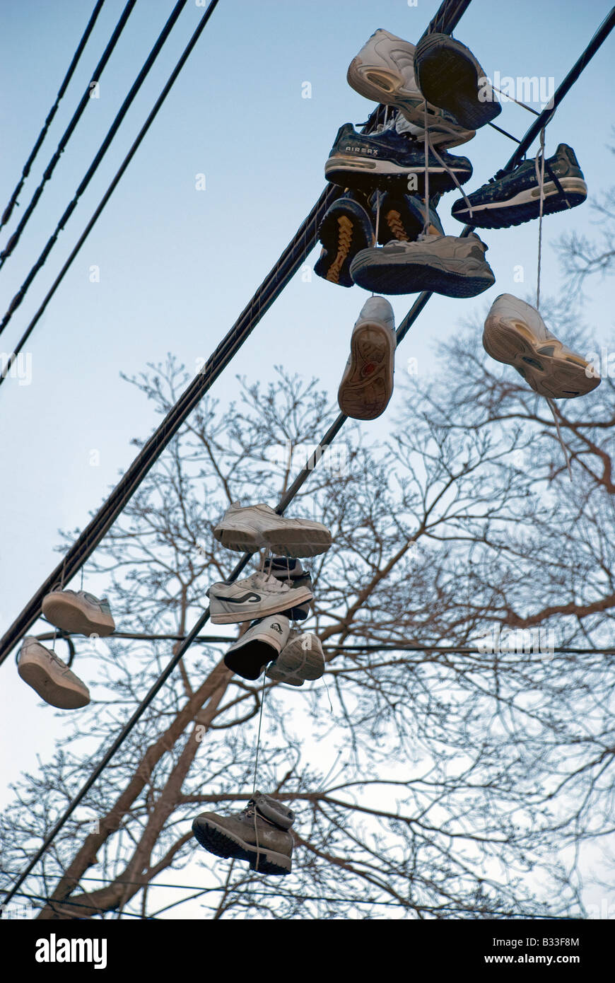 Eight pairs of tennis shoes over telephone wires Stock Photo Alamy