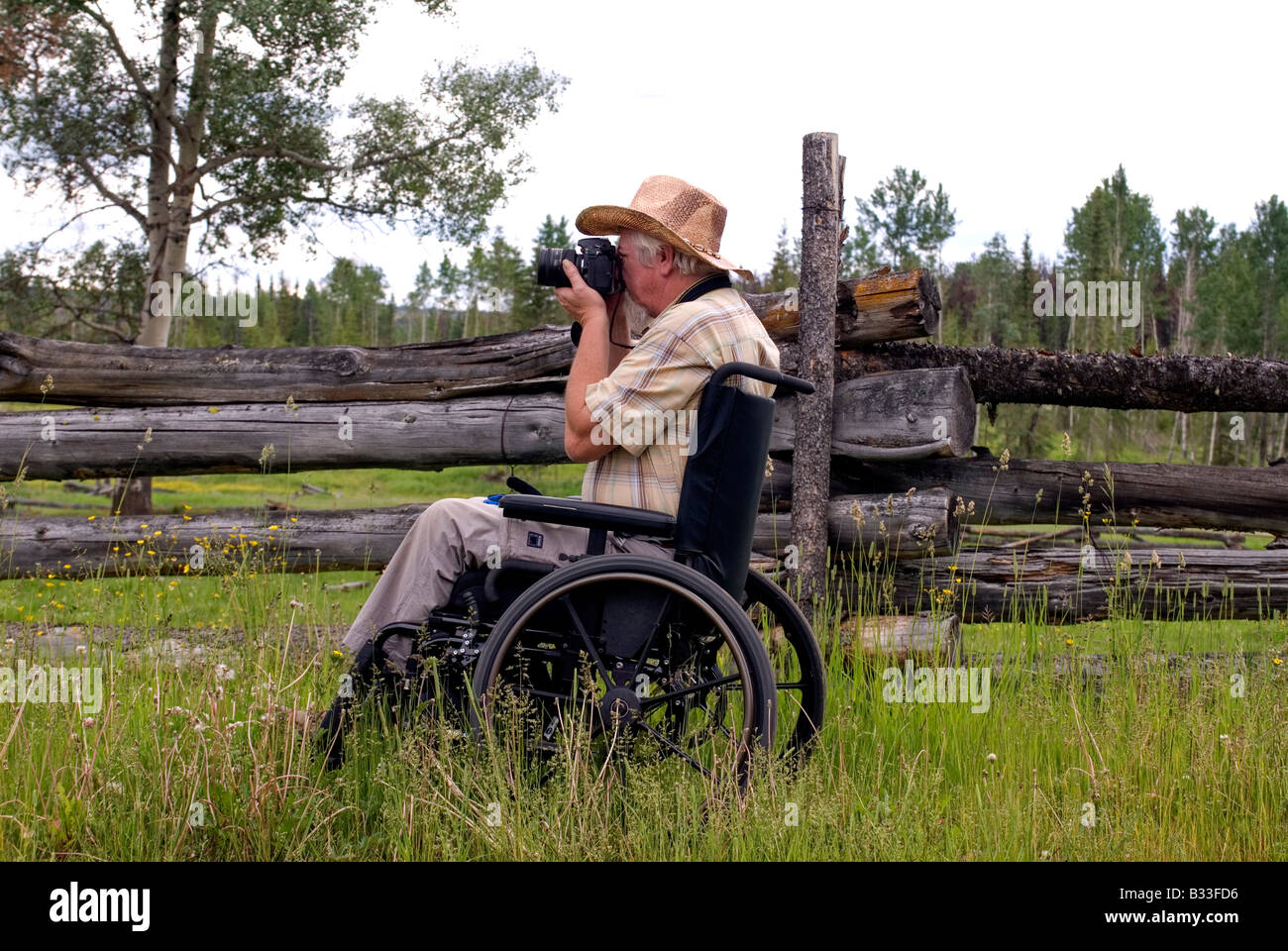 Handicapped male photographer taking photos at an abandoned ranch. Stock Photo