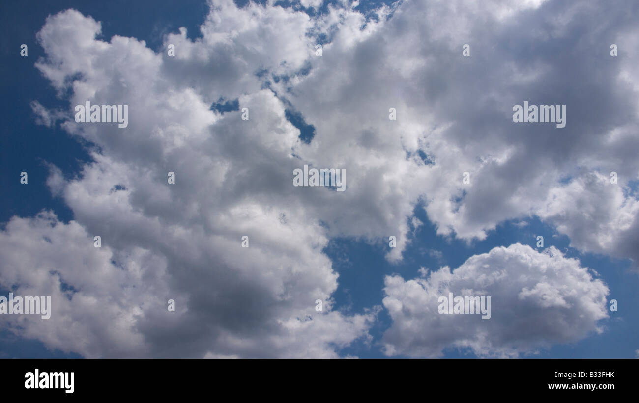 Fluffy white clouds and blue sky Stock Photo - Alamy