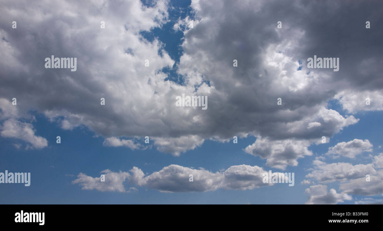Fluffy white clouds and blue sky Stock Photo - Alamy