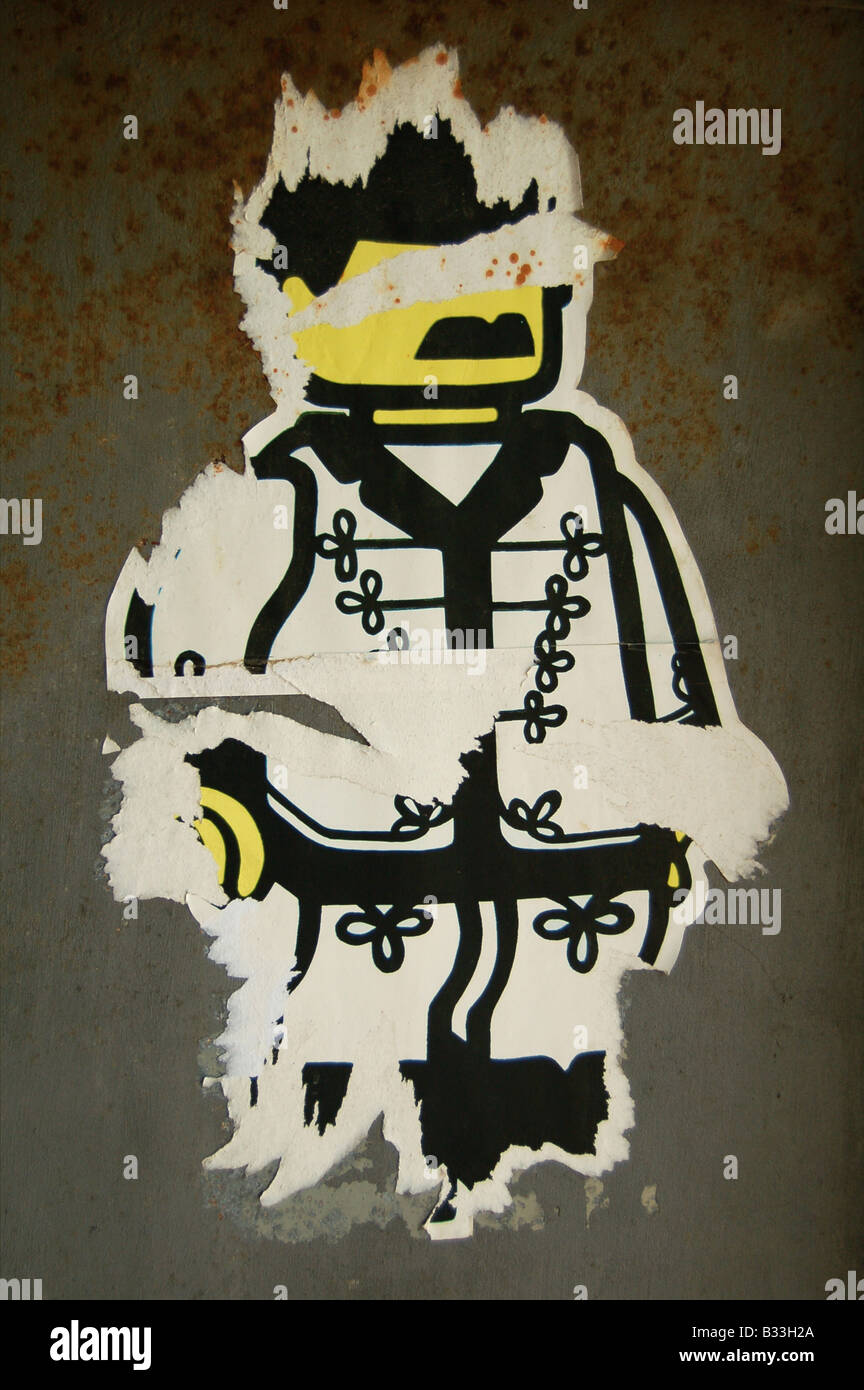 A fading old sticker depicting a 'Lego-man' wearing oriental clothing, found on a wall in Tel Aviv, Israel. Stock Photo