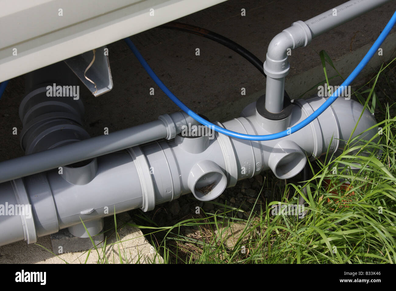 Sanitary pipes fitted under modern large site caravan. Stock Photo