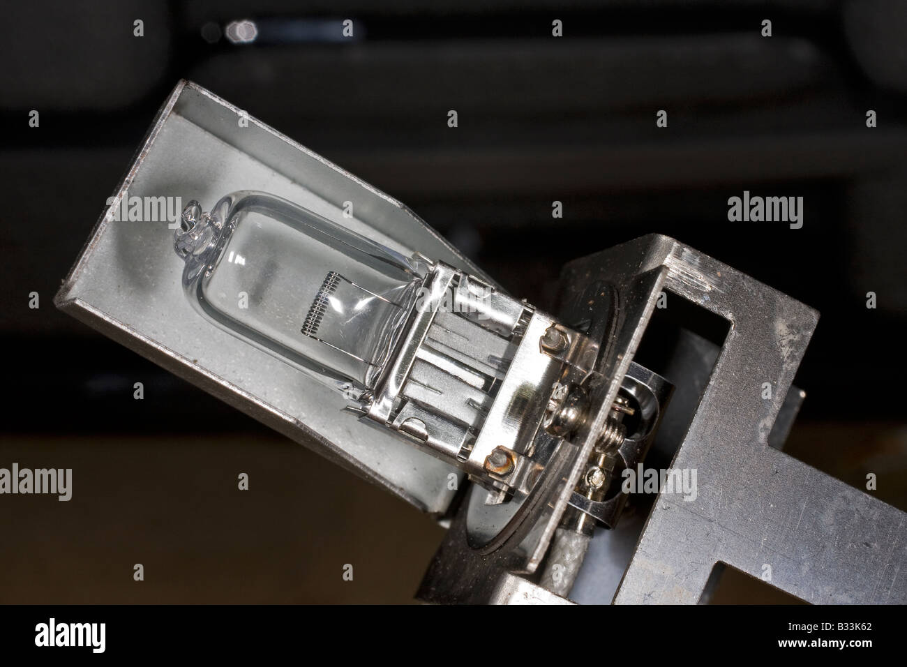 Halogen car headlight bulb in custom mount ready for fitting Stock