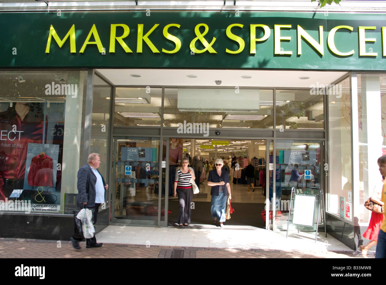 Marks and Spencer shop with two middle aged coming out Stock Photo Alamy