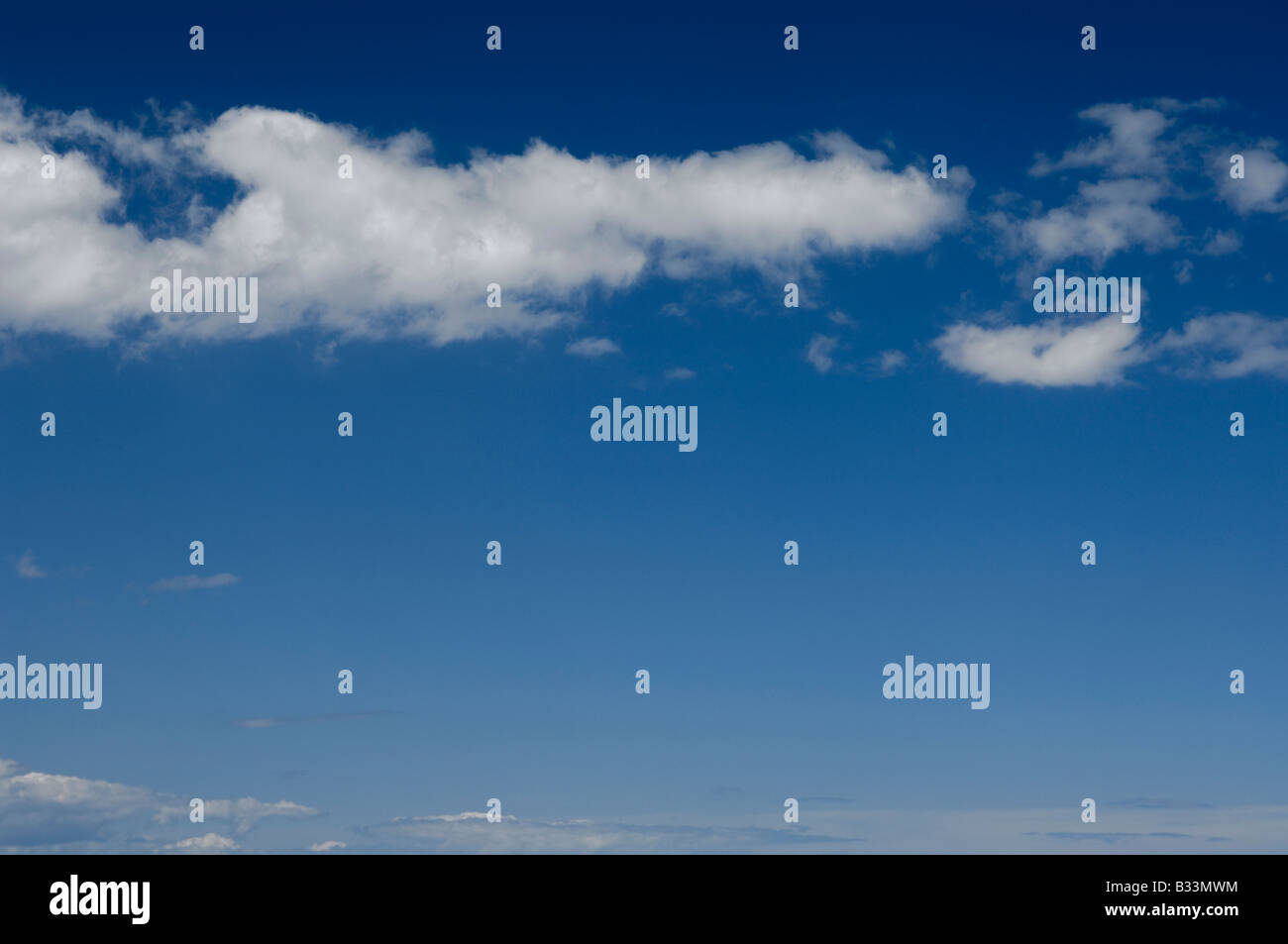 Fluffy clouds in a blue sky Stock Photo - Alamy