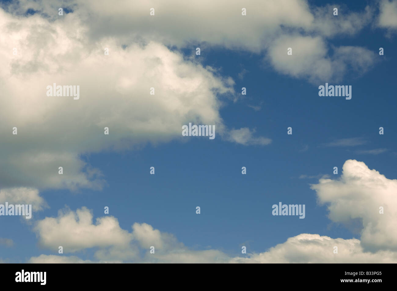 Fluffy clouds in a blue sky Stock Photo - Alamy