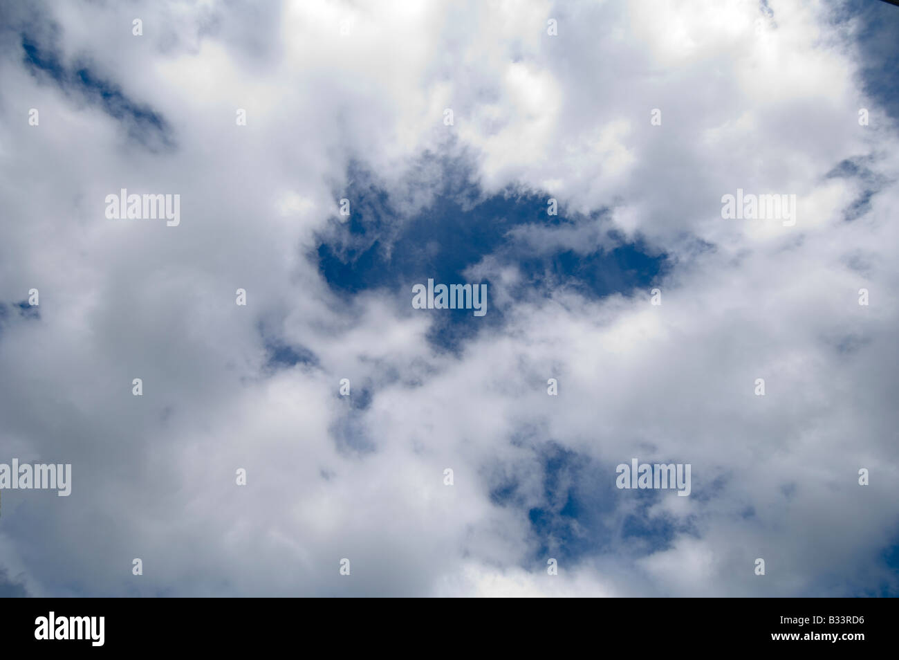 Fluffy clouds in a blue sky Stock Photo - Alamy