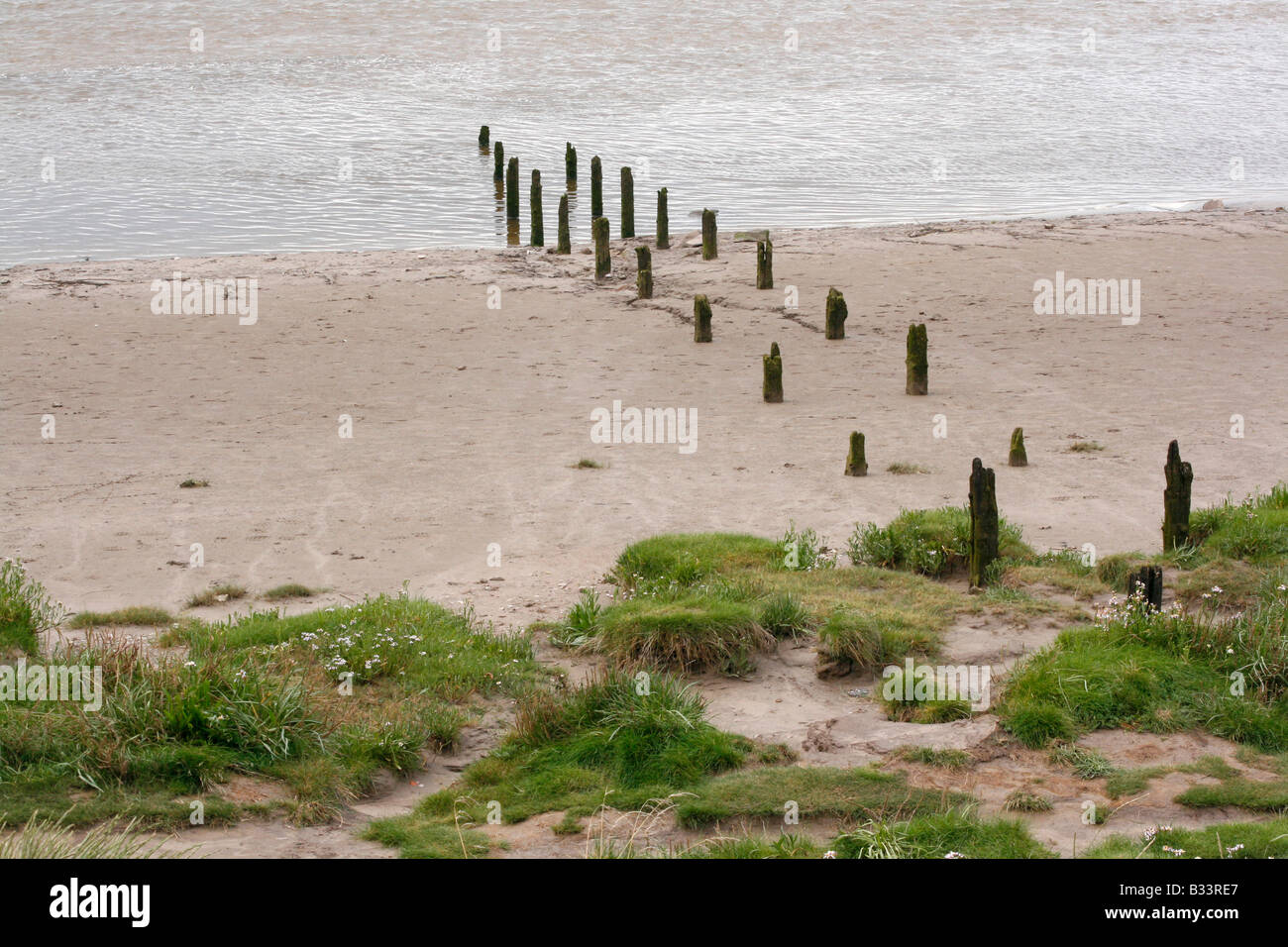 Arnside, Cumbria, The Lake District, UK.  Breakers &  low dunes on the sandy sea estuary shore. Stock Photo