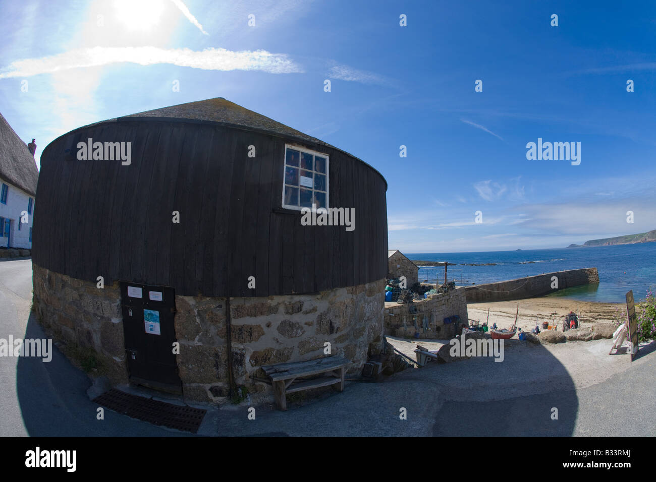 Sennen Cove Round House and harbour harbor in summer sunshine sea of Atlantic Ocean Cornwall West Country England UK Stock Photo
