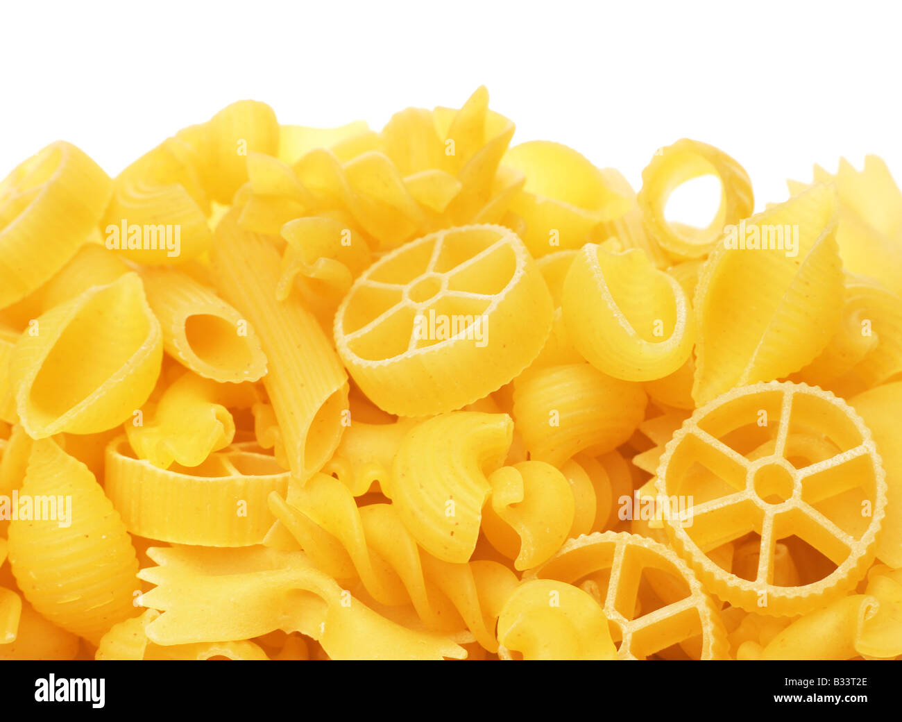Raw yellow pasta mix on white background Stock Photo Alamy