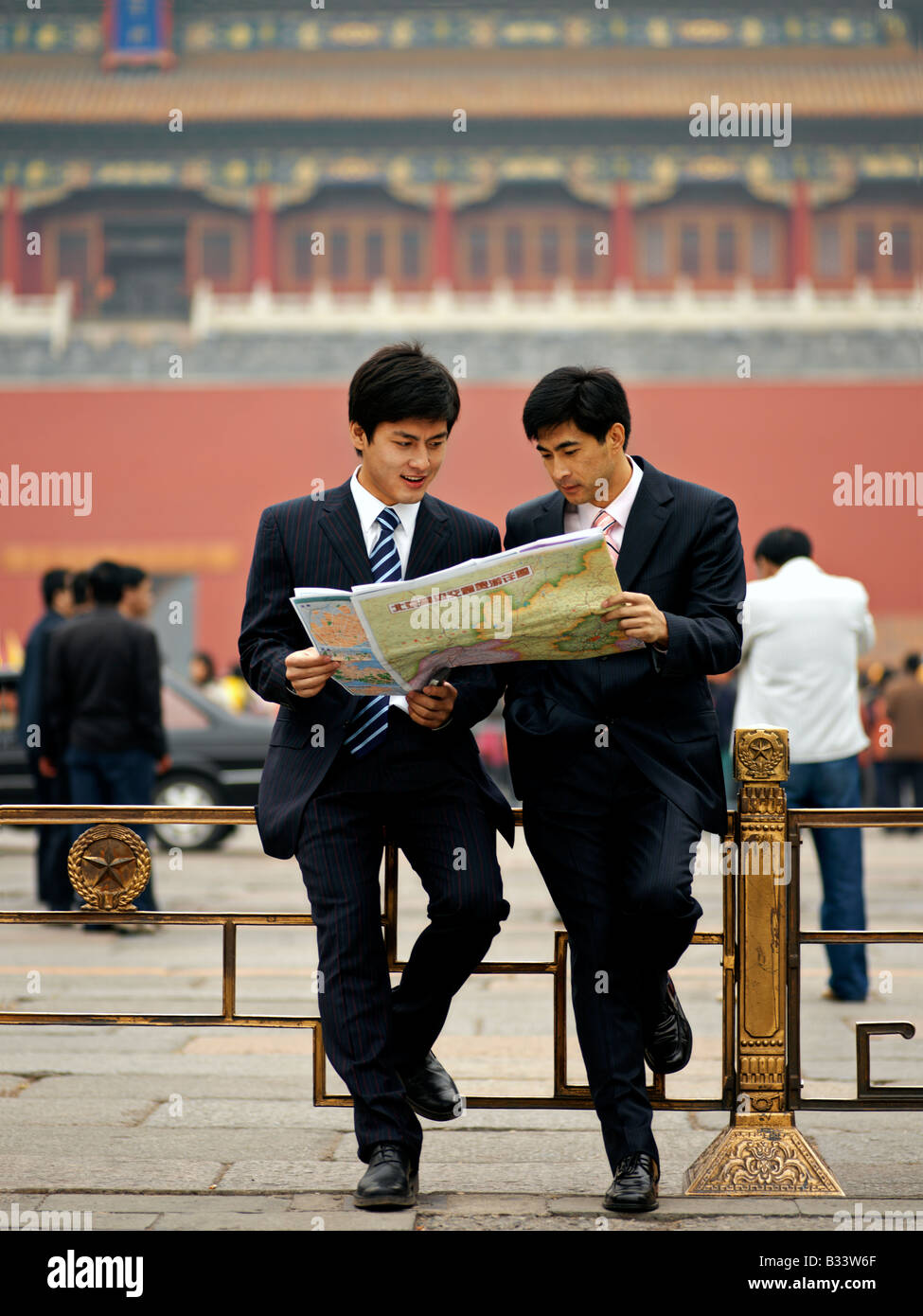 Chinese men looking at a map to help reorient or locate themselves. Stock Photo