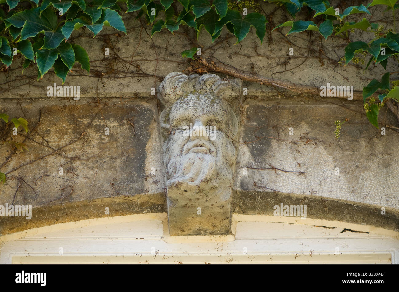 Stone carving of a face over top a window in the old courthouse in Niagara on the Lake, Ontario, Canada. Stock Photo
