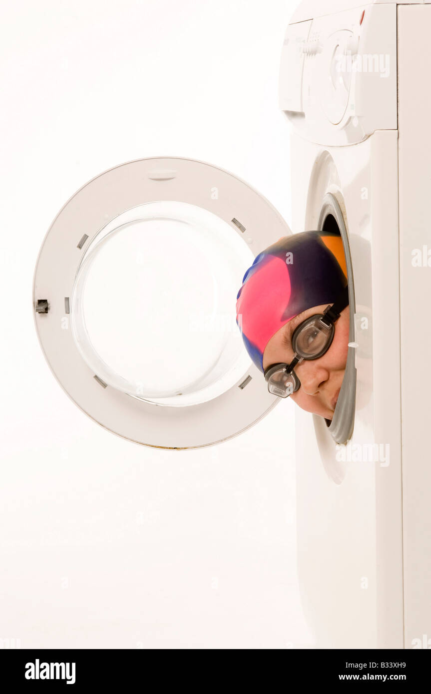 girl in swimming cap and goggles head appearing through door of
