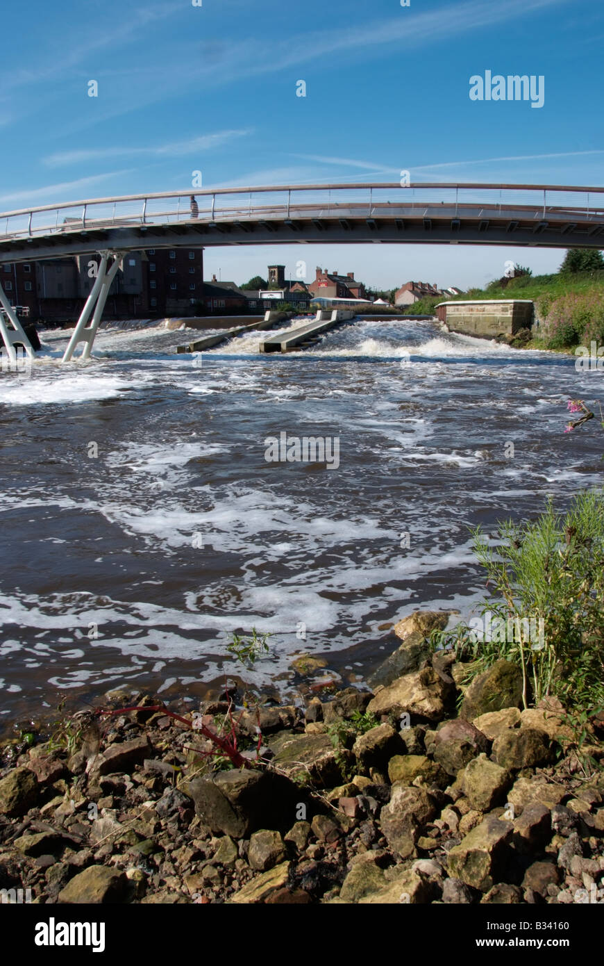 The new footbridge adjacent to the flour mill and the weir between Aire