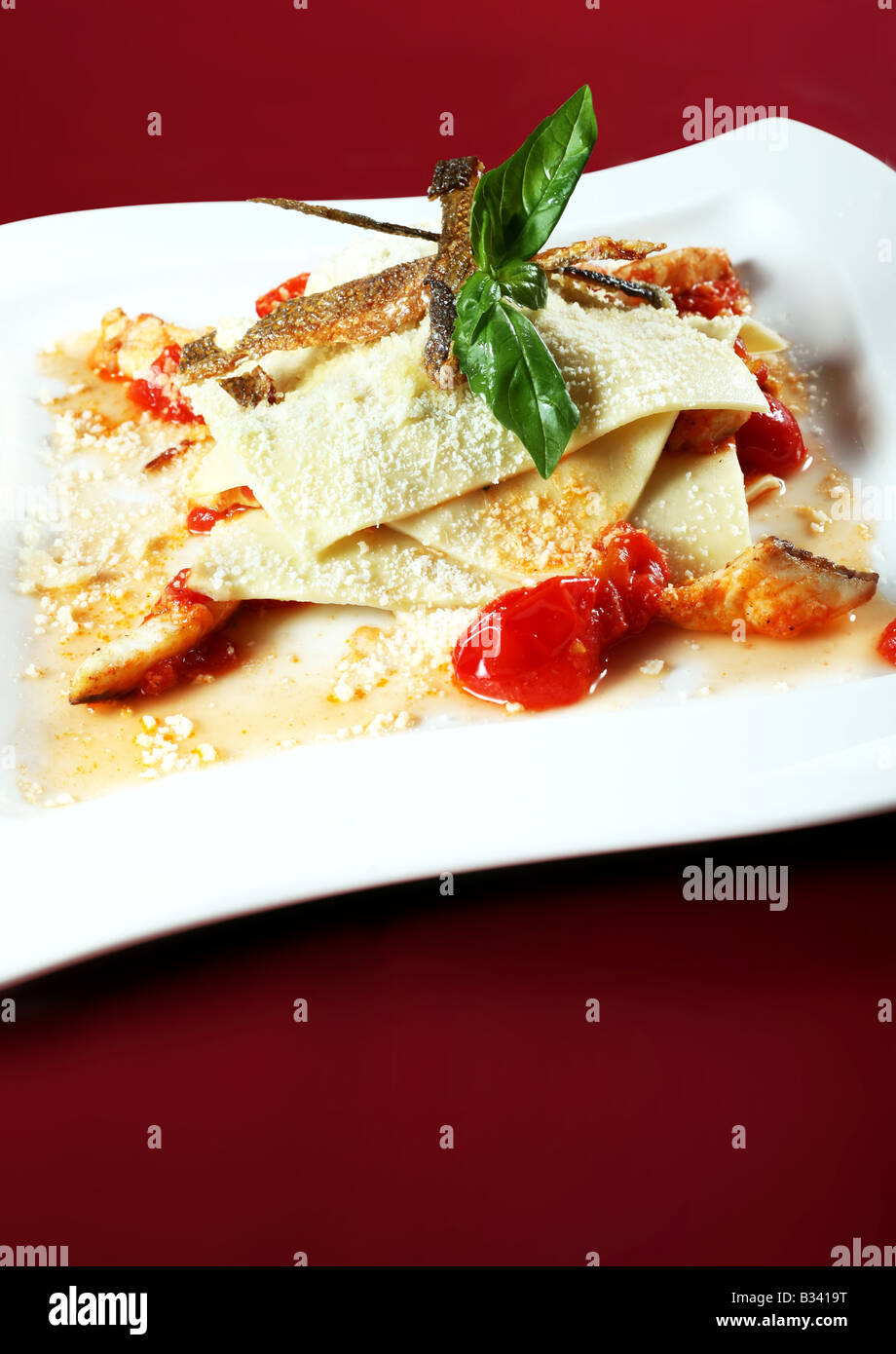 Fish and bakery with cherry tomato on square plate Stock Photo - Alamy