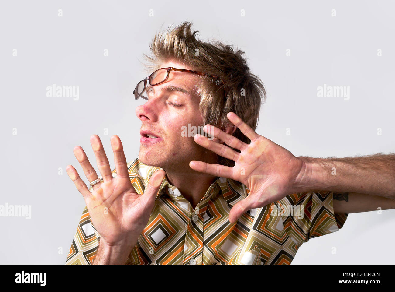 OVERWORKED MAN ASLEEP ON A PHOTOCOPIER GLASS PLATE SHOT FROM BELOW Stock Photo