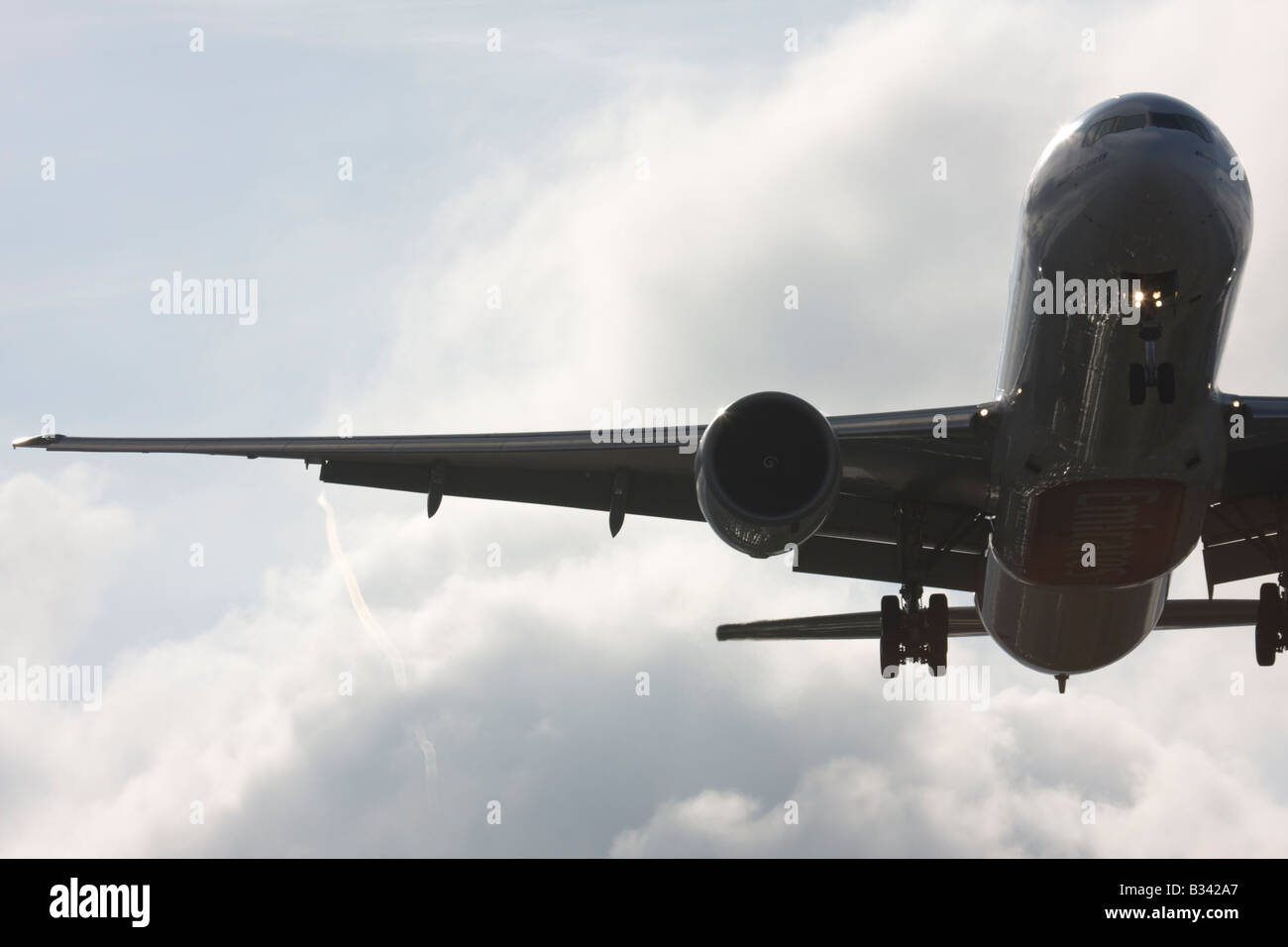 Commercial aeroplane on approach with visible wingtip vortices Stock Photo