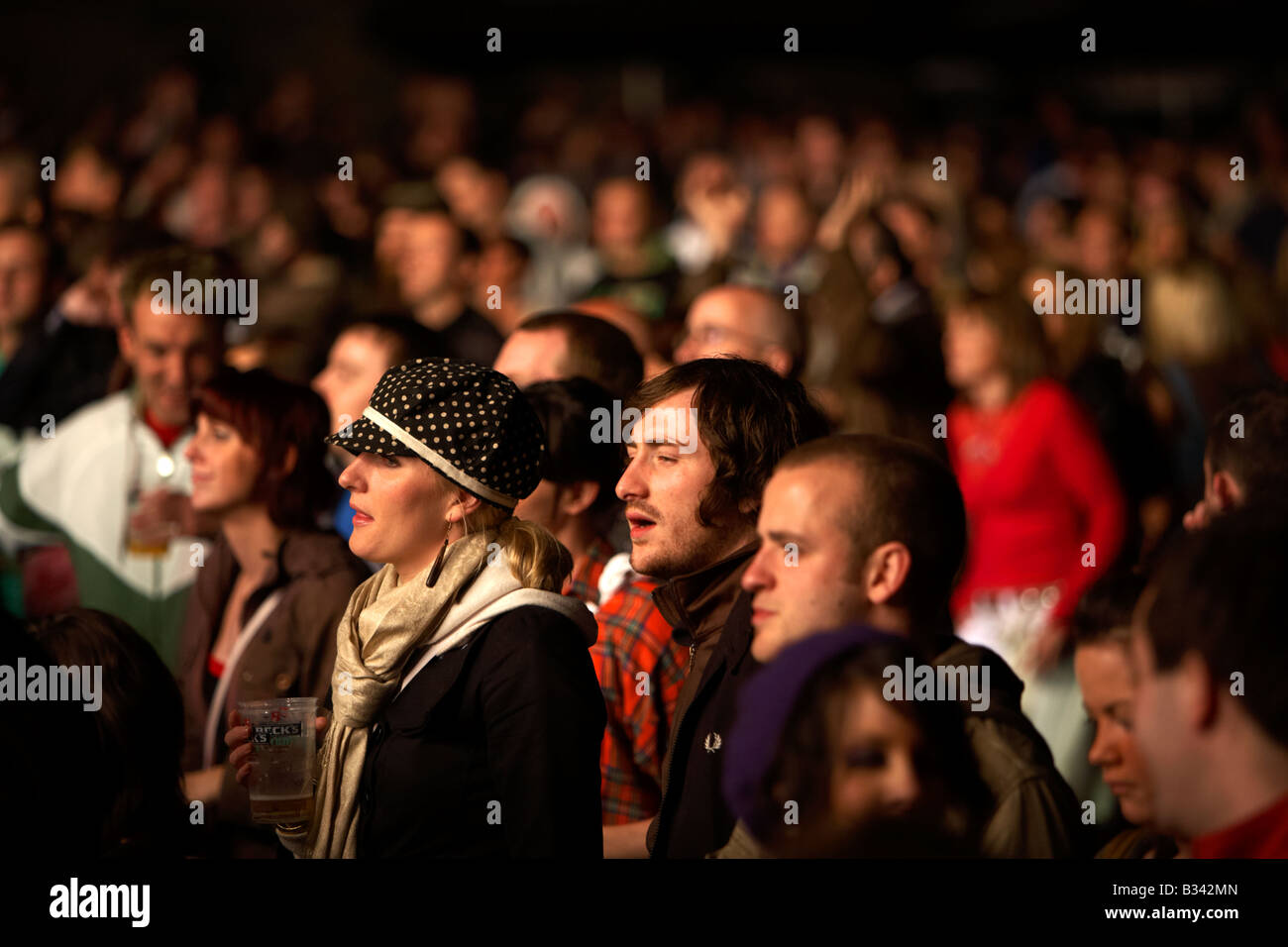 people looking bored in a crowd during a concert in Belfast Stock Photo