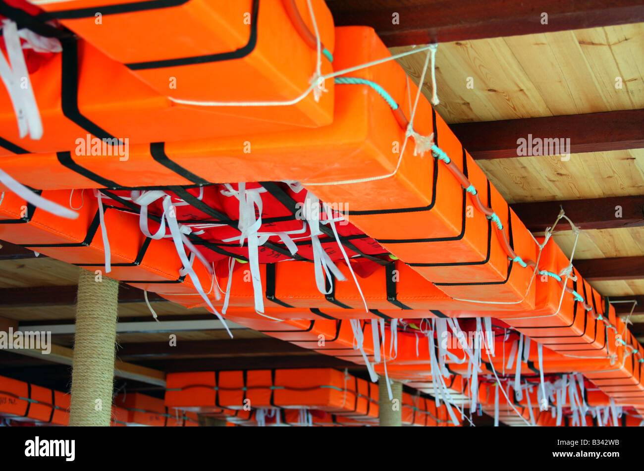 Orange life rafts attached on the sealing of the ship. Stock Photo