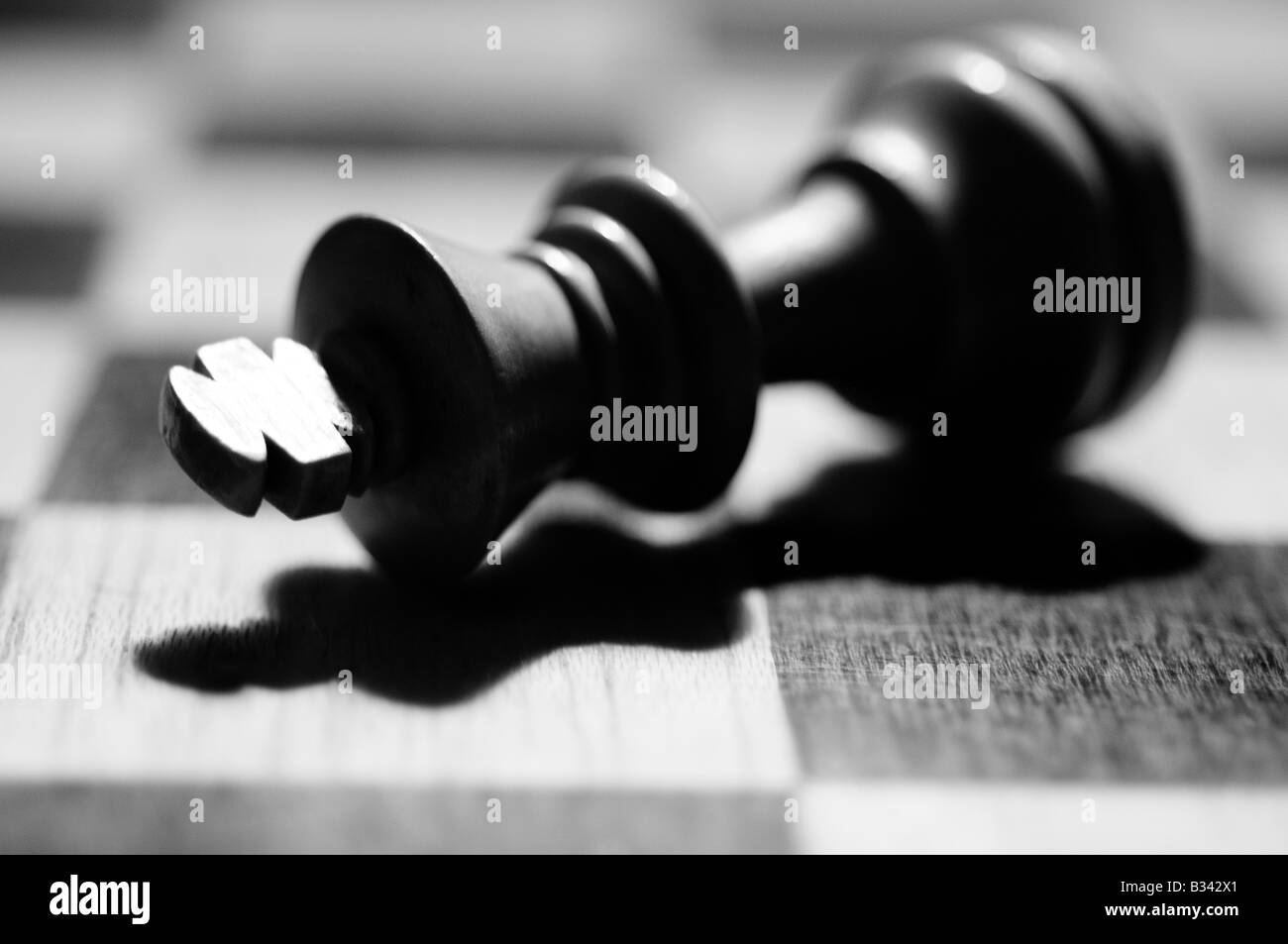 Close-up, detailed images of various chess pieces, queen, king, paws, black and white on a chessboard, resign defeat, checkmate Stock Photo