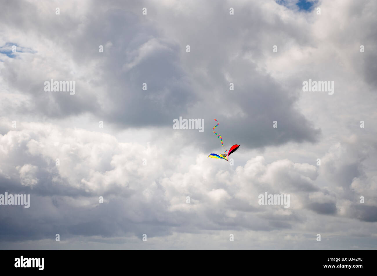 A kite high in the sky with clouds Stock Photo Alamy