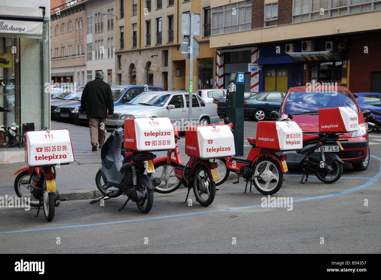 Line of moped motorbikes marked telepizza parked in Valladolid Spain Stock Photo