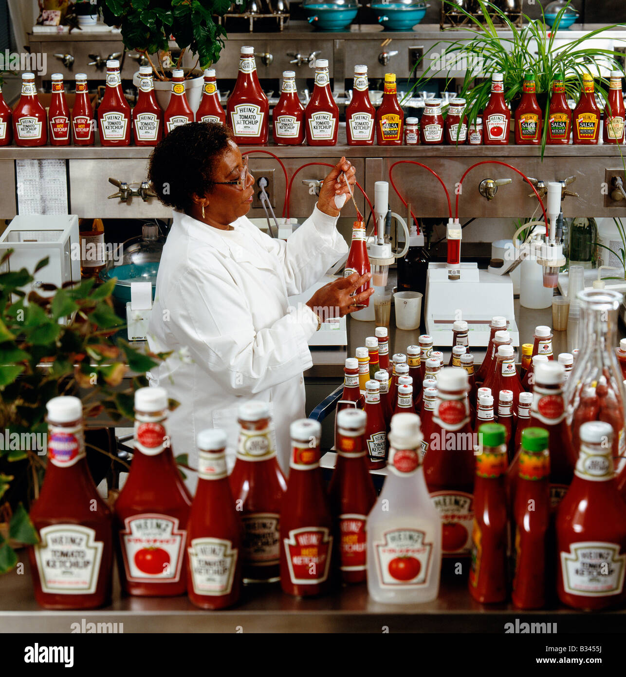 Technician performing quality control checks on ketchup in Heinz Foods
