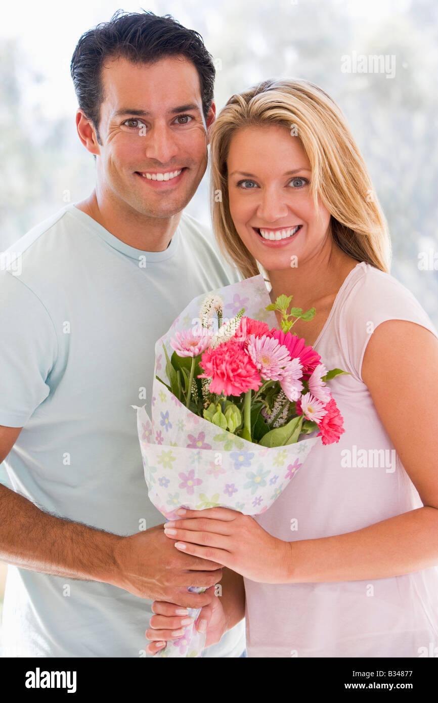 Husband and wife holding flowers and smiling Stock Photo Alamy