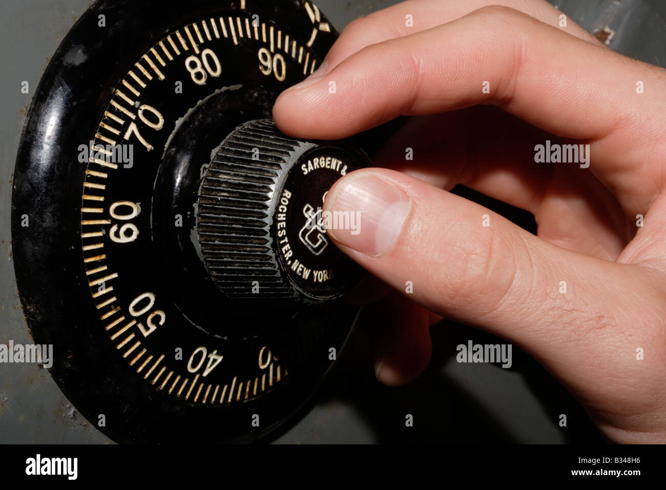Hand turning a safe combination dial Stock Photo