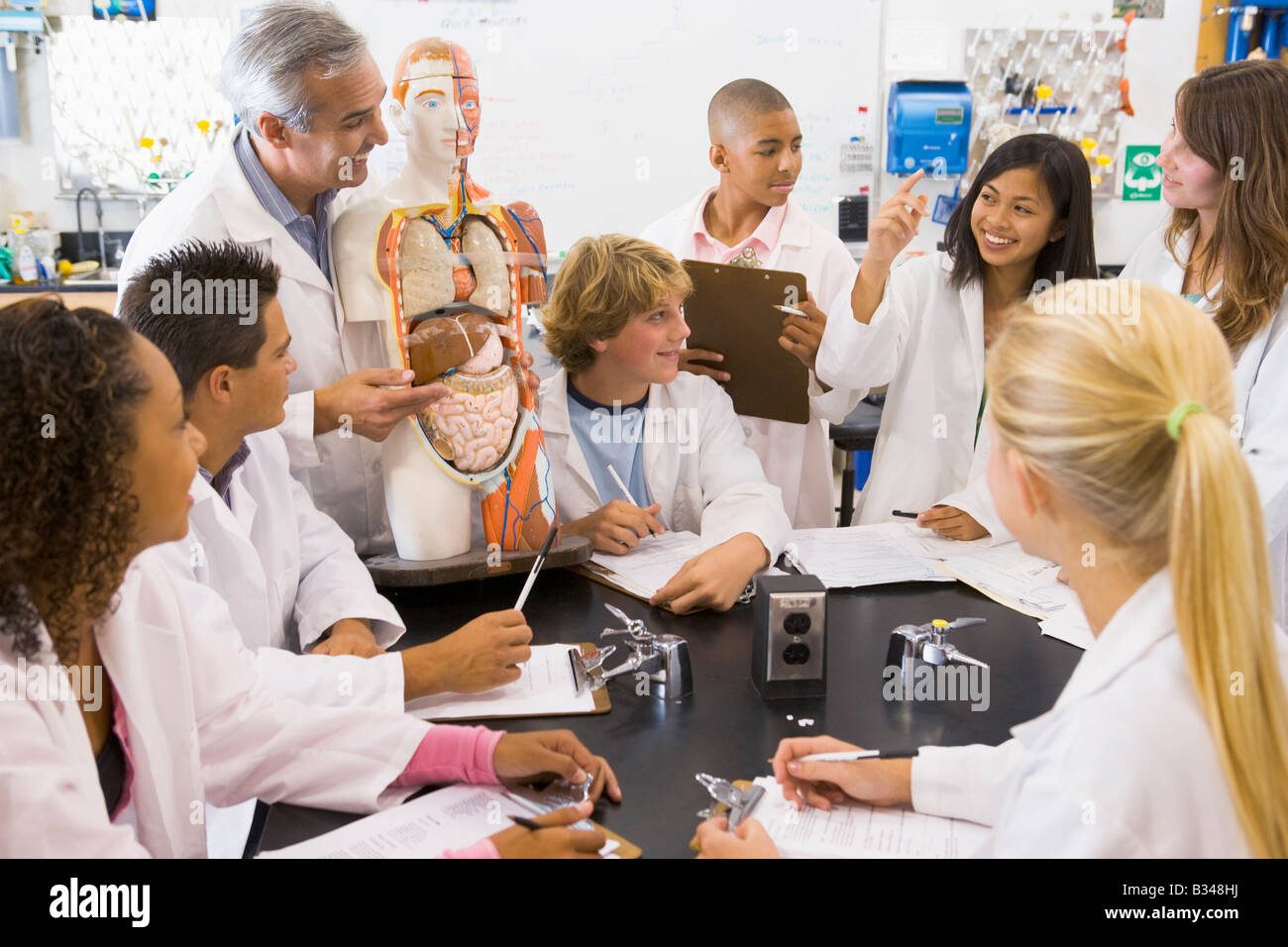 Students in biology class with teacher Stock Photo Alamy