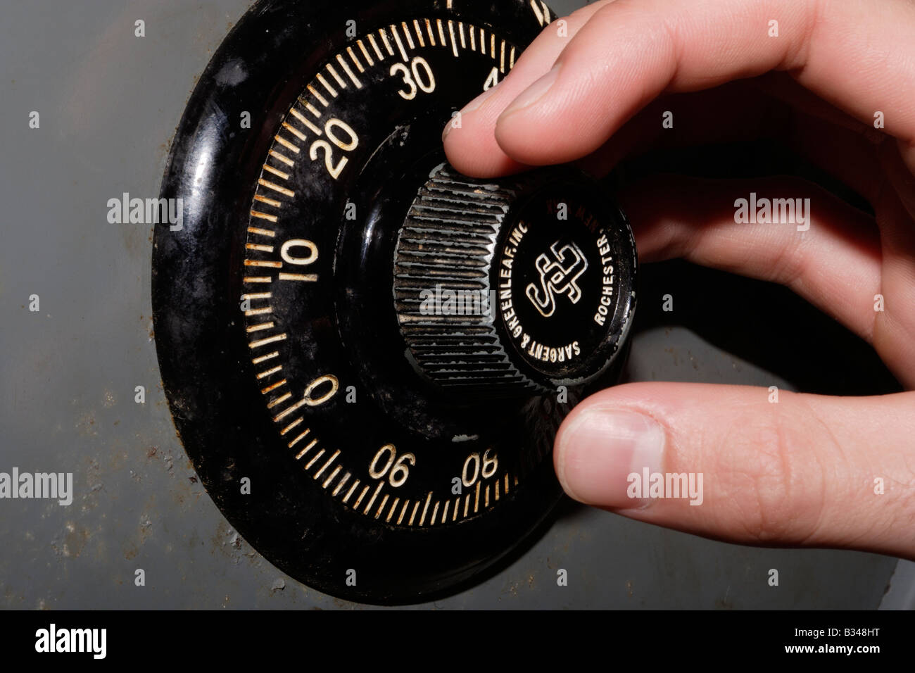 Hand turning a safe combination dial Stock Photo