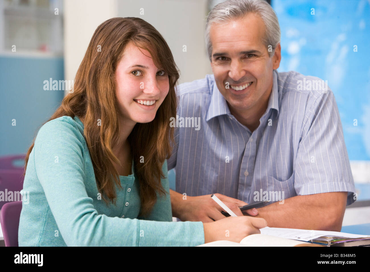 Teacher giving personal instruction to female student Stock Photo Alamy