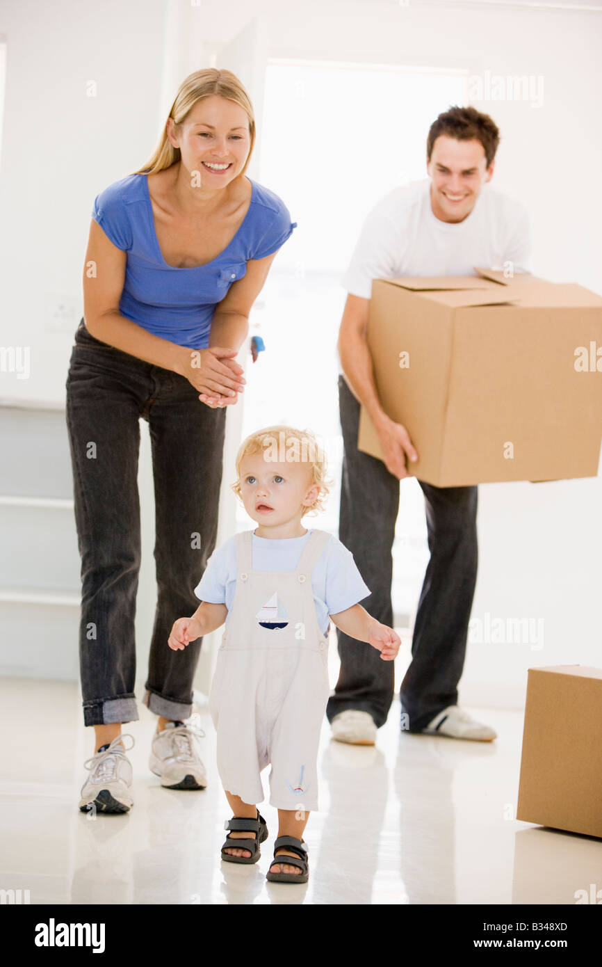 Family moving into new home smiling Stock Photo - Alamy